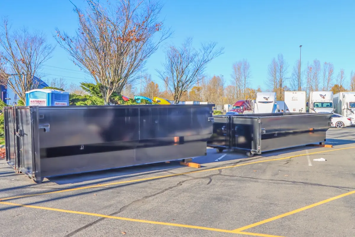 Professional dumpster rental service with roll-off container on residential driveway in North Ogden